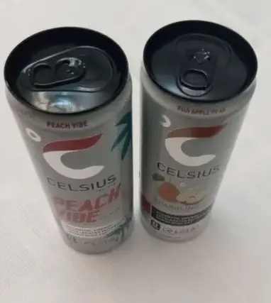 two celsius drinks on a table luxwisp